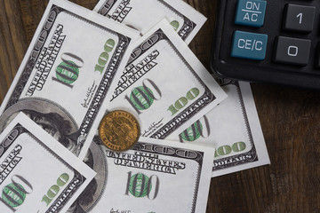 Fototapeta premium Banknotes, coins calculator on the wood table