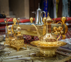 Fototapeta na wymiar Beautiful Golden arabic coffeepot brough out to welcome guests