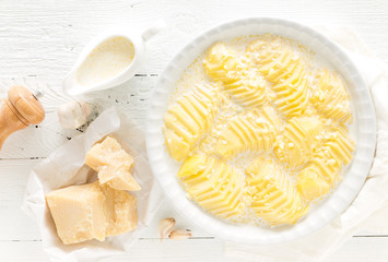 Cooking baked potato gratin with garlic, cream and parmesan cheese