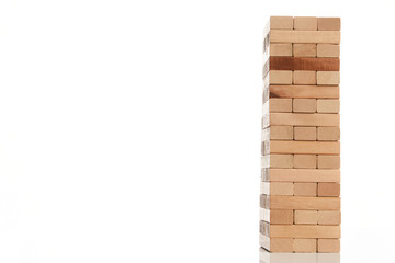Wooden blocks tower isolated on white background with copy space, close-up. Strategy game as a business plan for team work. Planning, risk and strategy of project management in business