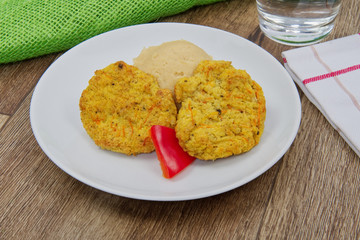 Vegetable slices and pea mash on a table