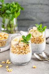 Layered chia pudding parfait with banana, sweet wheat with honey and yogurt, dessert