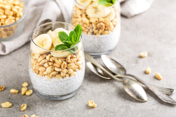 Layered chia pudding parfait with banana, sweet wheat with honey and yogurt, dessert