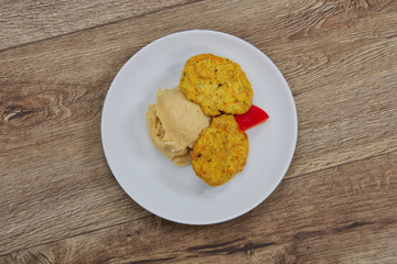 Vegetable slices and pea mash on a table