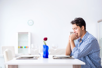 Man alone preparing for romantic date with his sweetheart