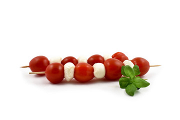 Skewer with mozzarella and tomatoes stock photo images. Mozzarella and tomatoes on a white background stock images. Piece of cheese with tomatoes and basil leaf. Healthy snack images