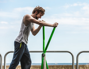 Active man exercising on elliptical trainer.