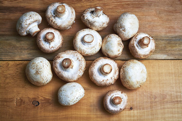 white champignons on wooden table
