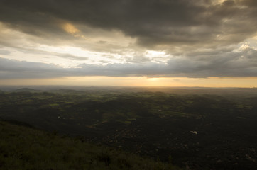 A sunset in clouds by the mountain