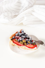 erving homemade mix berry tart with fresh berries.