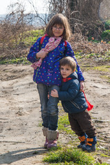 Brother and sister pose in nature