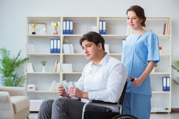 Fototapeta premium Disabled patient on wheelchair visiting doctor for regular check