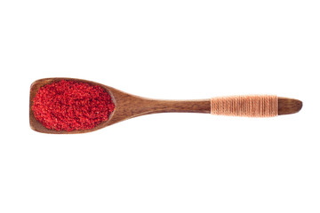 spice chili pepper powder in  wooden spoon isolated on a white background, top view