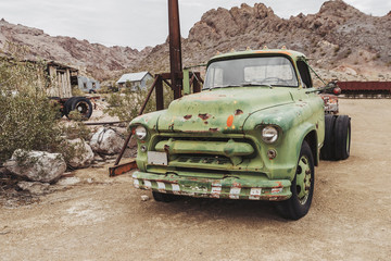 Old vintage rusty car truck abandoned in the desert