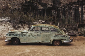 Old vintage rusty car truck abandoned in the desert
