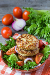 Salad  and homemade cutlets  on a plate.