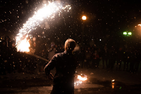 A man with a lighted torch, a fire show