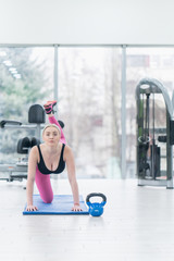Fototapeta premium Woman Kettlebell training in gym