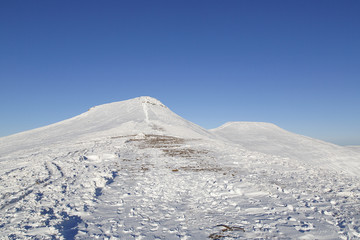 Pen y Fan and Corn Du are the highest mountains in the Brecon Beacons National Park - with winter snow. - obrazy, fototapety, plakaty