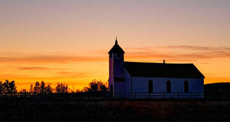 Fototapeta premium An old country church at sunrise, Alberta, Canada