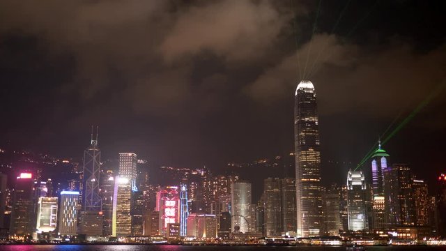 a laser show at victoria harbour and the ifc building as seen from tsim sha tsui promenade in hong kong, china