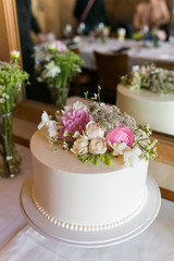 White wedding cake with pink flower, rose