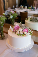 White wedding cake with pink flower, rose