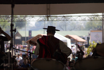 A man wearing a hat at an event celebrating the culture and tradition of the Gaucho people in southern Brazil.