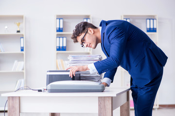 Businessman making copies in copying machine