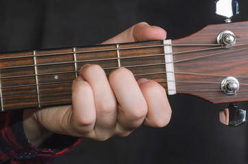  Musician Playing accord Am on acoustic guitar, close up
