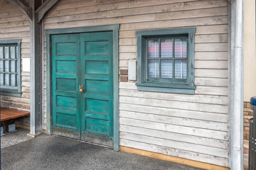 The old wooden door and glass window in blue frame