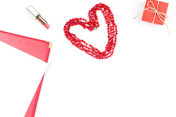 Lipstick, heart shape and giftbox on white background. Women's Day concept flat lay.
