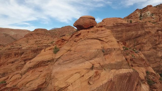 Aerial circiling a red rock sandstone pillar in Southern Utah