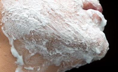 Fototapeta na wymiar A man is applying face shaving foam