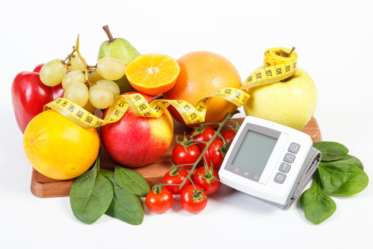Blood pressure monitor, fresh ripe fruits with vegetables and centimeter, healthy lifestyle