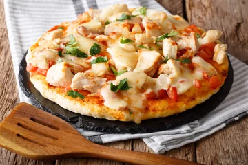 Crédence de cuisine en verre imprimé Pizzeria Nourriture délicieuse : pizza au bison avec poitrine de poulet, concasse de tomates et gros plan de fromage mozzarella sur la table. horizontal