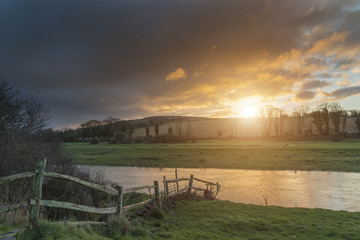 Beautiful Winter sunrise landscape of Cuckmere River winding through South Downs countryside in England