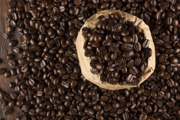 Coffee beans in sackcloth on table close up