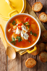 Delicious chicken buffalo soup with tomatoes, celery, carrots and blue cheese close-up in a saucepan. vertical top view