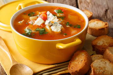 buffalo soup with chicken, vegetables and blue cheese closeup in the pan and toasted bread on the table. horizontal