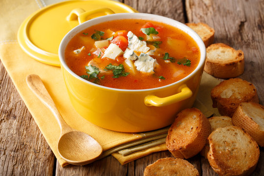 Hot buffalo soup with chicken, vegetables and blue cheese close-up in a saucepan and bread. horizontal, rustic style