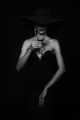 Luxury woman in a black hat with Martini glass in hand. - 192797933
