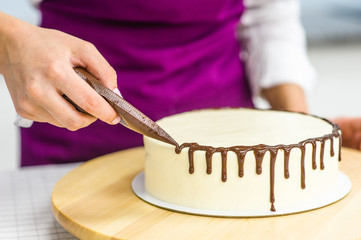  Close up woman is decorating the cake