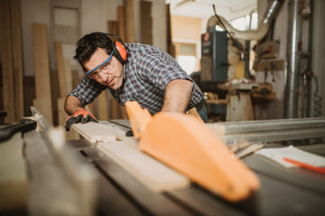 carpenter works with manual and electric equipment