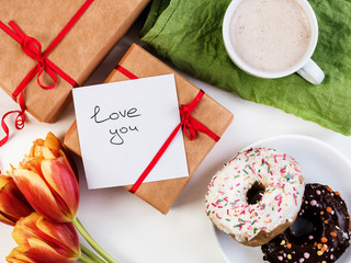 Bouquet of flowers, gift, tender note and delicious breakfast for a loved one