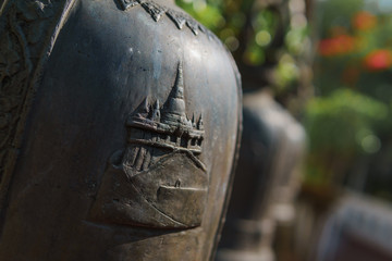 Cultural carving on a metal bell in Bangkok, Thailand