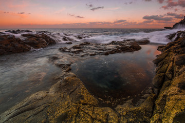Long Exposure sunrise, colorful sky, volcanic rock beautiful seascape at Gran Canaria Island Coast in Spain.