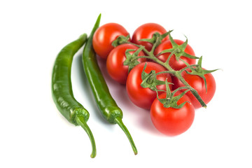 tomatoes and green peppers on a white background