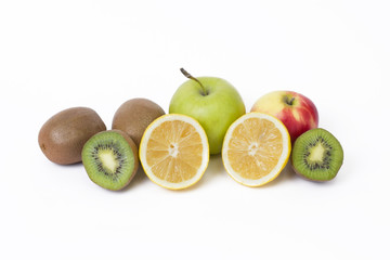 Fruits in a composition on a white background. Lemon with apples and kiwi on white background. Fruits with carrots on a white background.
