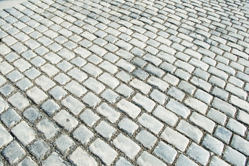 Road paved with cobble stones for your background